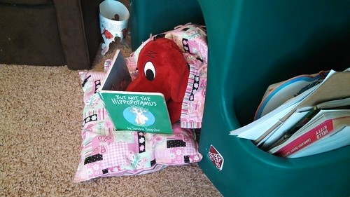 Clifford reading before taking a nap. In his dog house