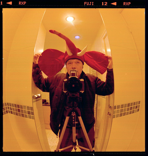 reflected self-portrait with Pentacon Six camera and elephant hat by pho-Tony