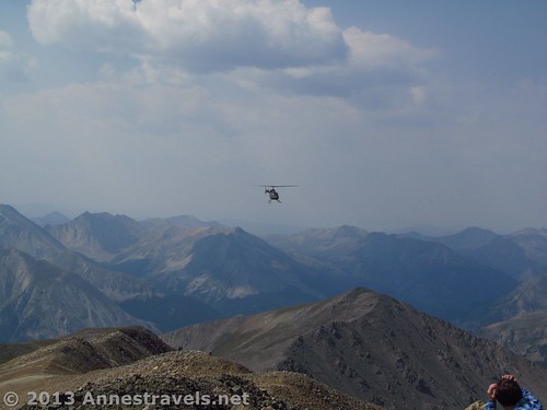 A helicopter circles near the summit of Mount Elbert, San Isabel National Forest, Colorado