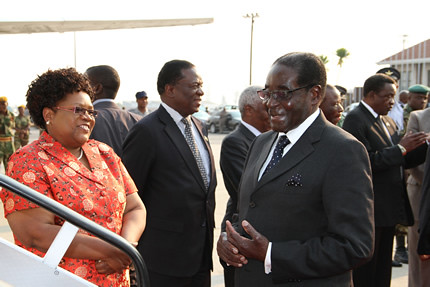 Republic of Zimbabwe President Robert Mugabe and Vice-President Joice Mujuru at Harare International Airport prior to the president's departure for the SADC Summit in Lilongwe, Malawi on August 17, 2013. by Pan-African News Wire File Photos
