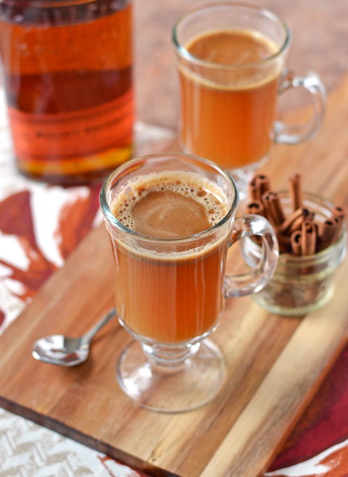Two glasses of festive cocktails and cinnamon