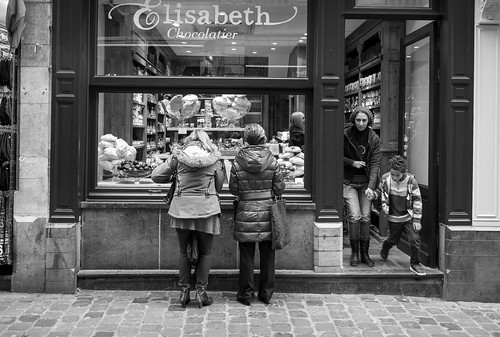 Take time to stop and just wait for things to happen. I was originally photographing the two women window shopping for chocolate in Brussels when a mother and child exited.