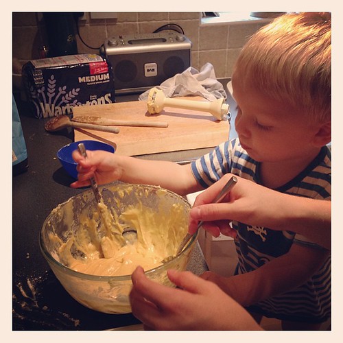 Making cakes with his big sister.