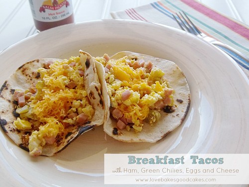 Breakfast Tacos with Ham, Green Chilies, Eggs and Cheese on plate with fork.