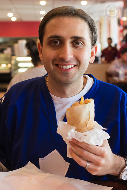 husband holding a shawarma in hand