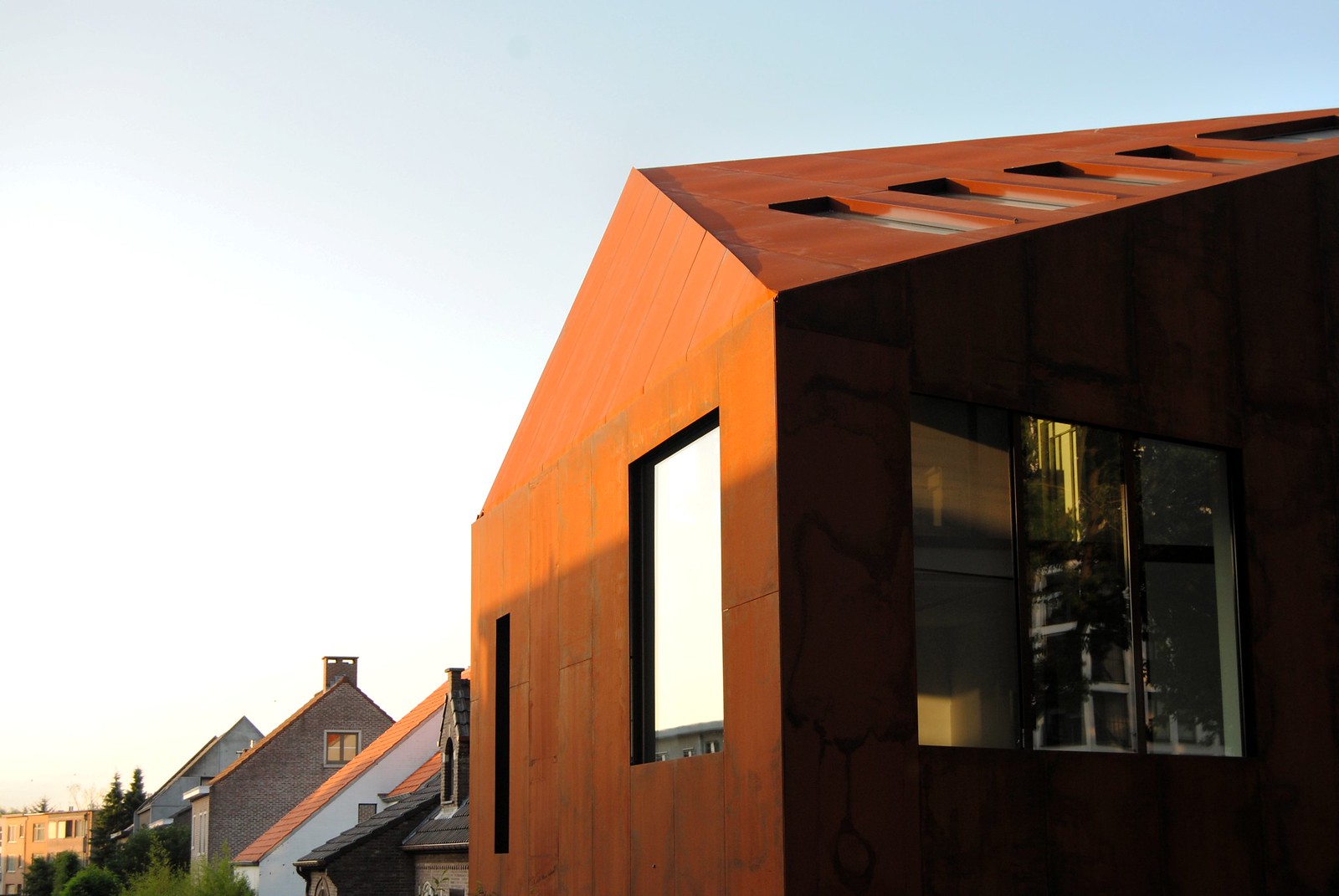 A copper-toned house features contemporary, geometric architecture.