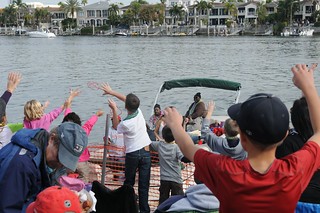 Coast Guard Sector St. Petersburg crew members and their friends and family cheer as the 2014 Gasparilla Parade and Pirate Festival passes by Sector St. Petersburg's Prevention Department, at Davis Islands, Fla., Saturday, Jan. 25, 2014. Coast Guard, Coast Guard Auxiliary and Florida Fish and Wildlife Conservation Commission officers teamed up with local law enforcement agencies to keep waterways safe during the event. (U.S. Coast Guard photo by  Seaman Meredith Manning)