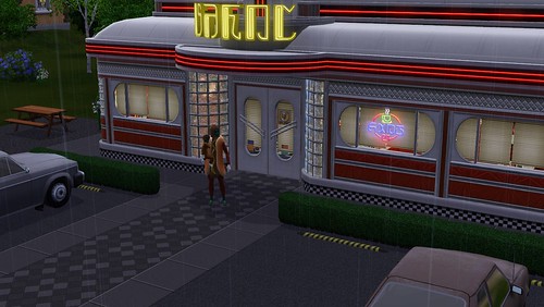 A hot dog and his child stand in the rain outside the diner