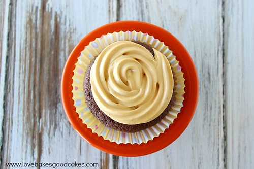 Mexican Chocolate Cupcakes with Dulce de Leche Cream Cheese Frosting. Cupcake on red plate top view.