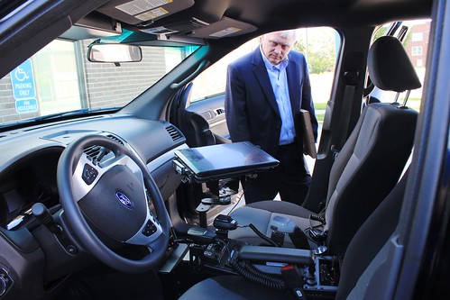 Indiana USDA Rural Development State Director Philip Lehmkuhler inspects the equipment in Jasonville’s new police vehicle.