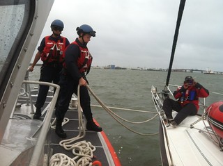 Crew members from Coast Guard Station Cape May assist boaters who are aboard a 44-foot sailboat offshore from Cape May, N.J., Saturday, Oct. 12, 2013. The Coast Guard's 45-foot Response Boat - Medium crew was already underway when they spotted the boaters stranded in the heavy weather and towed them to safety. (U.S. Coast Guard photo by Fireman Michael Deugwillo)