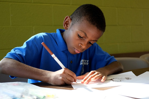 Child doing homework at a Community Center where Kids Café is held. Image provided by Feeding America.