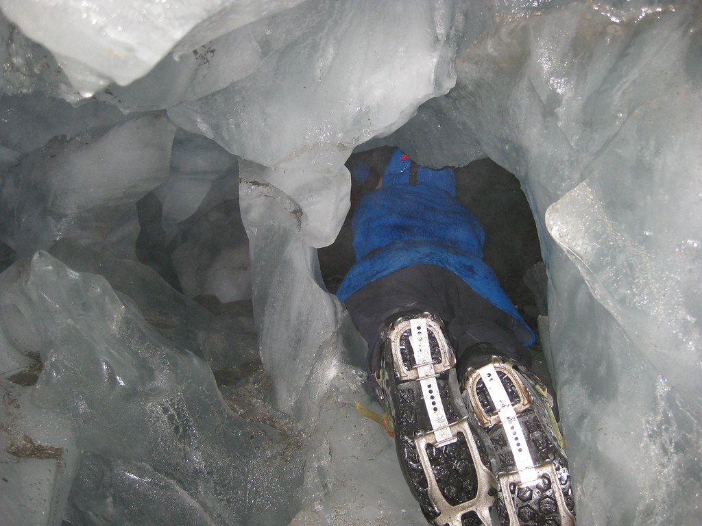Crawling through an ice cave on Franz Josef Glacier - New Zealand