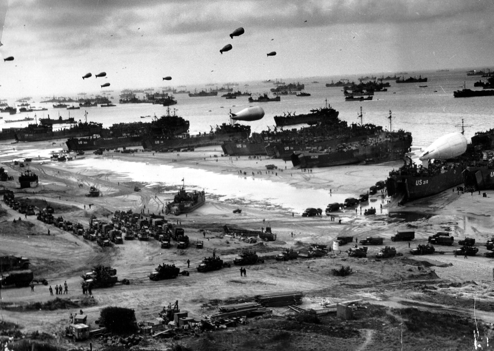Landing ships putting cargo ashore on one of the invasion beaches, at low tide during the first days of the operation, June 1944