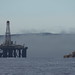 Oil rig under tow, fog clearing