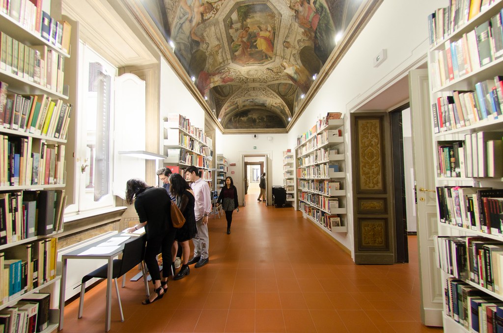The library ceiling fresco runs the length of the room and the two architecture studios are accessible from the space.