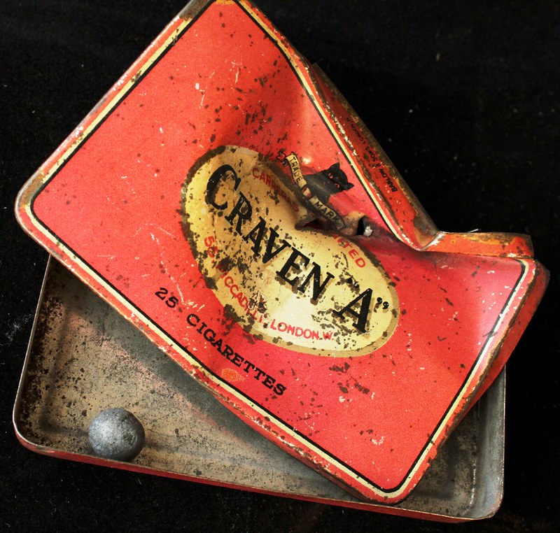 WWI: Cravan A cigarette tin with the shot it stopped still inside
