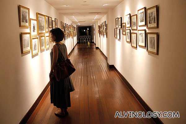 Rachel slowly strolling down the wall of fame in Raffles Hotel