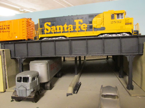 A 1970's era Atchison, Topeka & Santa Fe Railroad freight train idles above the urban viaduct. by Eddie from Chicago