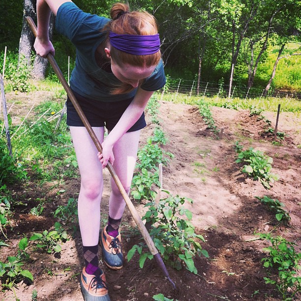 Olivia in her garden, hilling potatoes #organic #farm #homestead #teen #unschooling #maine