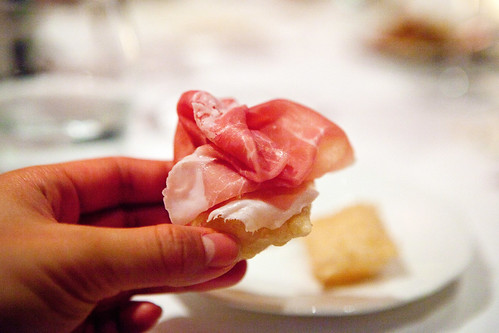 How to eat Gnocco Frito properly - topping it off with a slice of shaved prosciutto