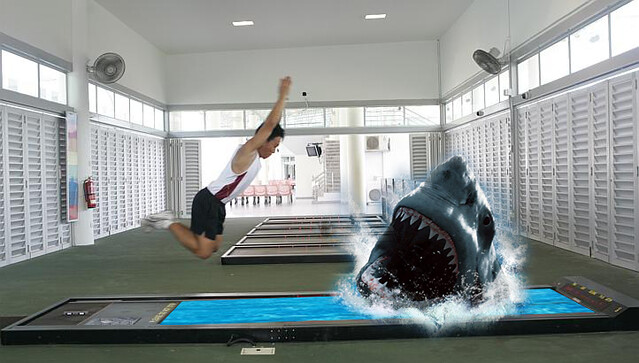 Because normal standing broad jump is too mainstream. Add some sharks.