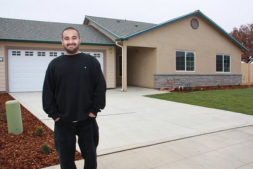 Robert Tapia, a single father of two, is pictured outside the Reedley, Calif. home he proudly helped build with ten other families through USDA's Mutual Self-Help Housing Loan program in partnership with Self-Help Enterprises, which celebrated the completion of its 6,000th home last week. (USDA photo)