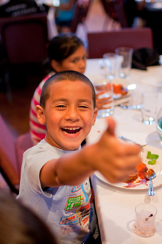 A child at a summer meals site enjoys a tasty and nutritious meal.  