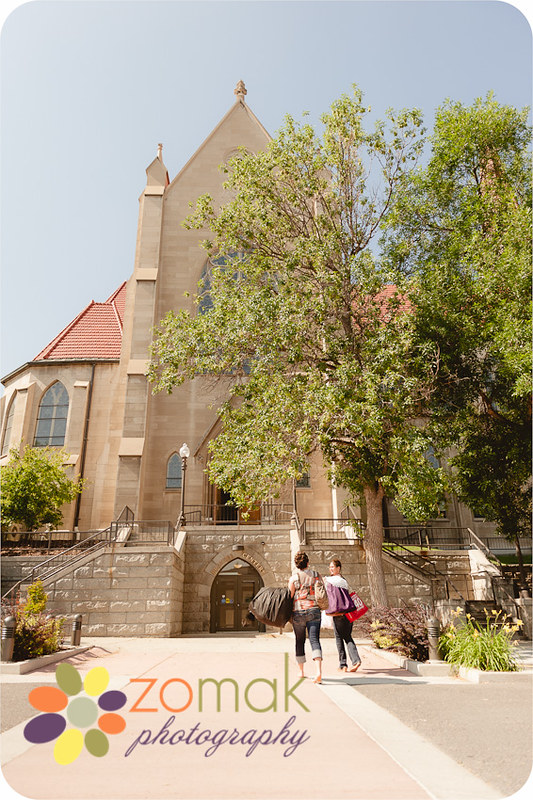 Bride and her maid of honor approach the St Helena Cathedral on her wedding day with gown in hand