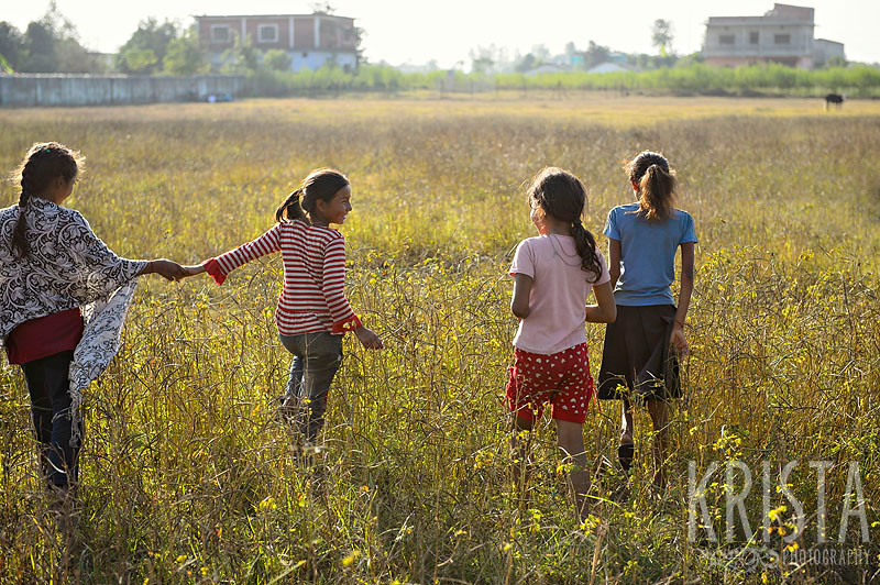 Nepalese Girls walking in a field