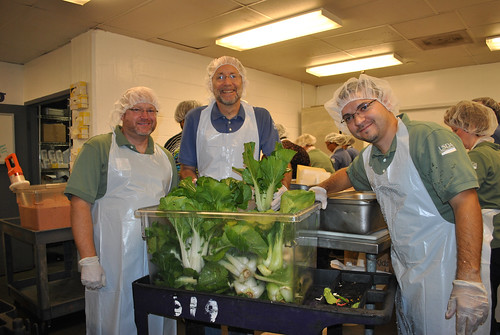 (L to R) DC Central Kitchen in Washington, D.C. Rich Holcomb employee, U.S. Department of Agriculture (USDA) National Agricultural Statistics Service (NASS) Brian Lounsbury, and USDA, National Institute of Food and Agriculture (NIFA) Dewell Delgado Paez stand with a bin of just washed bok choy that was grown USDA headquarters Peoples Garden in Washington, D.C. USDA photo.