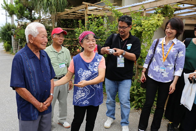 Ms Emiko Kinjo (centre) introducing one of the elderly villagers in Ogimi Village