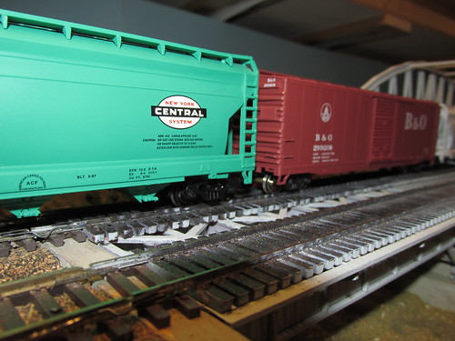 A 1960's era American freight train in H.O scale passes by. by Eddie from Chicago