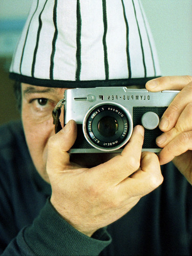reflected self-portrait with Olympus Pen FT camera and striped hat by pho-Tony
