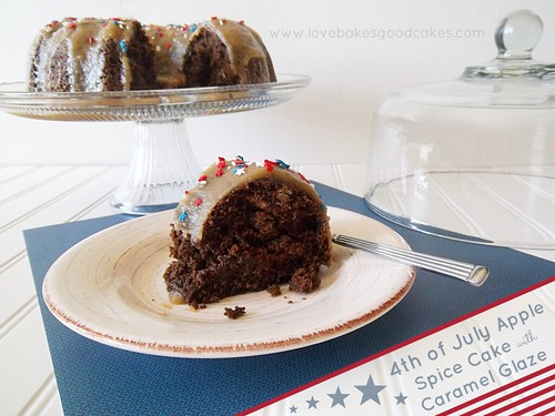 4th of July Apple Spice Cake with Caramel Glaze on cake stand with one piece cut on plate with fork.