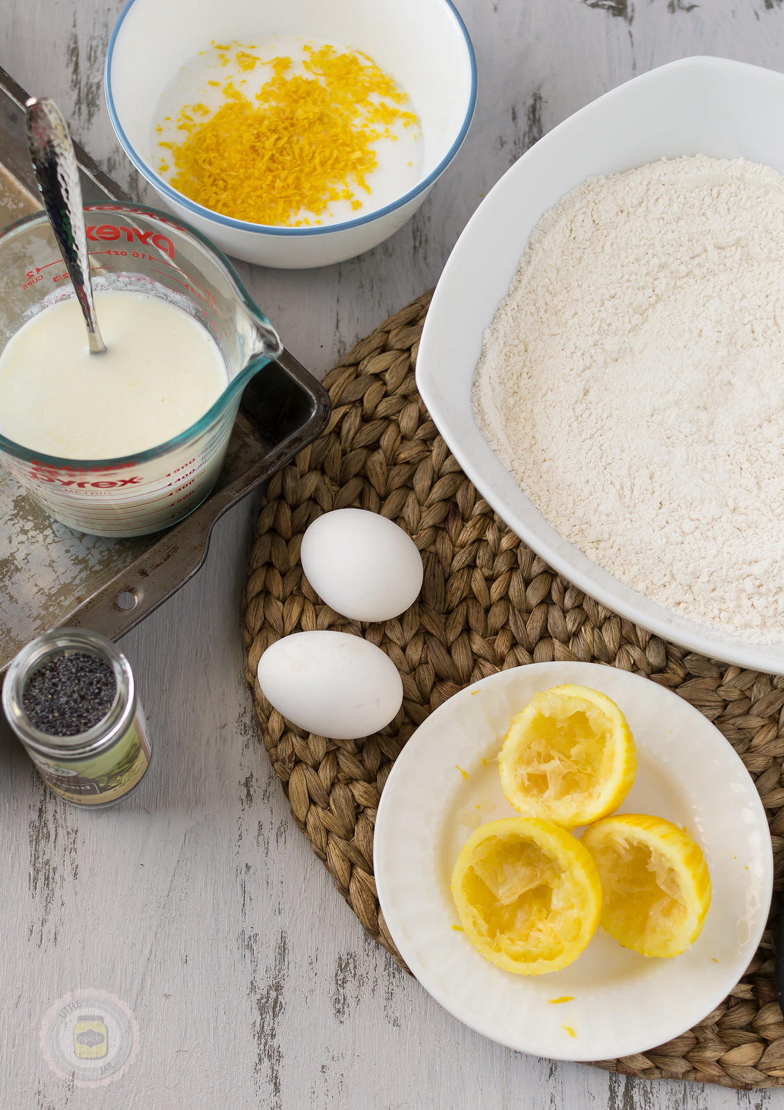 measured ingredients for lemon muffins on white surface 