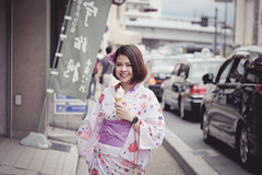 young asian woman wearing kimono standing with icecream