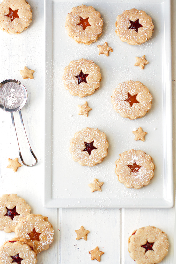 Raspberry Almond Linzer Cookies - Almond shortbread cookies sandwiched together with raspberry jam in the center. These cookies are sooo good! | Littlespicejar.com