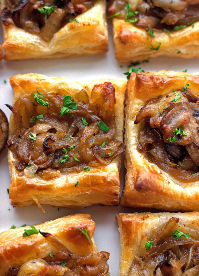 caramelized onion puff pastry squares on serving plate