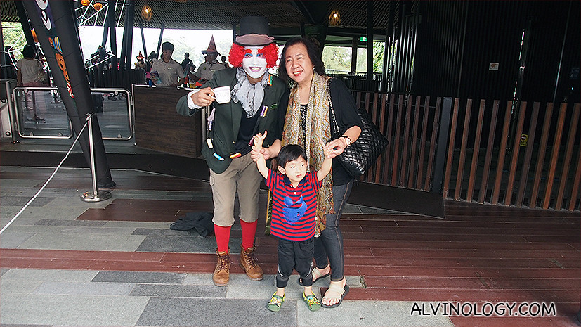 My mum and Asher with a staff from River Safari during a Halloween event last year 