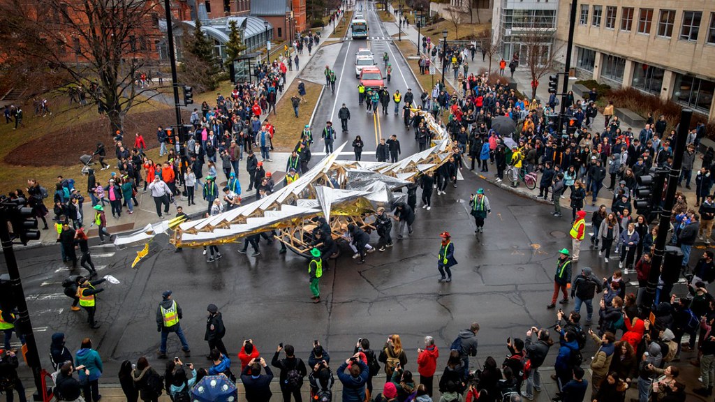 The annual Dragon Day parade passes Sage Hall on the way to the Engineering Quad.