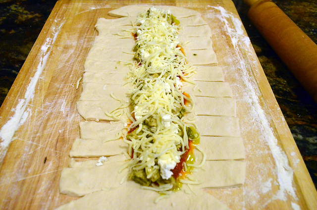 Shredded Mozzarella cheese added on top of the dough.