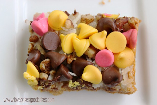 Springtime Magic Cookie Bars are a soft baked graham cracker cookie bar topped with coconut, pecans and Springtime morsels! #cookie #bars #coconut #chocolate