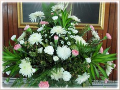 Bouquet of white chrysanthemums, pink carnations, greens and other fillers
