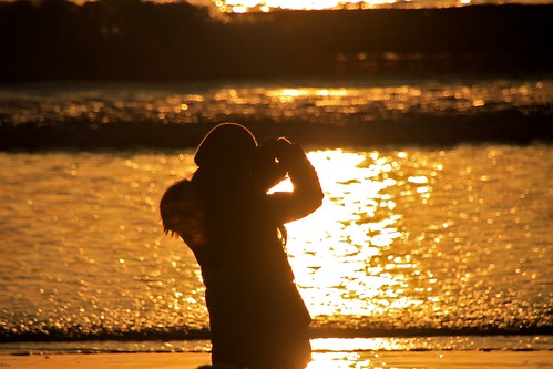 sunset reflection beach silhouette photographer wave