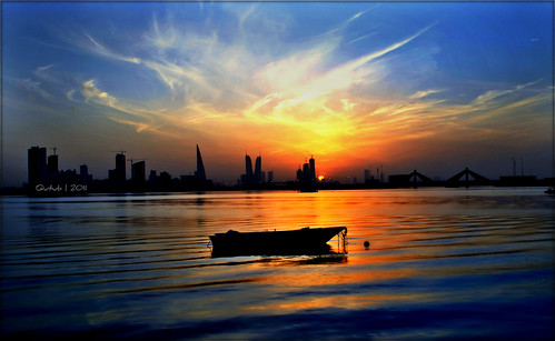 ocean blue sunset sea sky reflection water skyline clouds boat bahrain towers silhoutte arabiansea