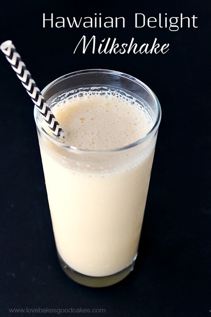 Hawaiian Delight Milkshake in a clear glass with a black and white straw. 