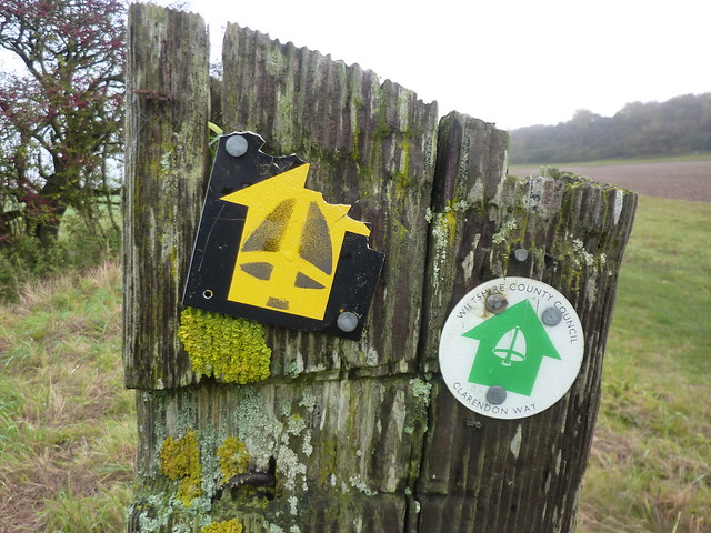 Old and new Clarendon Way logos on an old fence post