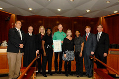 Governor Rick Scott and others posing with a Resolution recognizing the Guardian ad Litem Program after the Governor's Cabinet meeting at the Capitol on January 18, 2012 in Tallahassee, Florida.