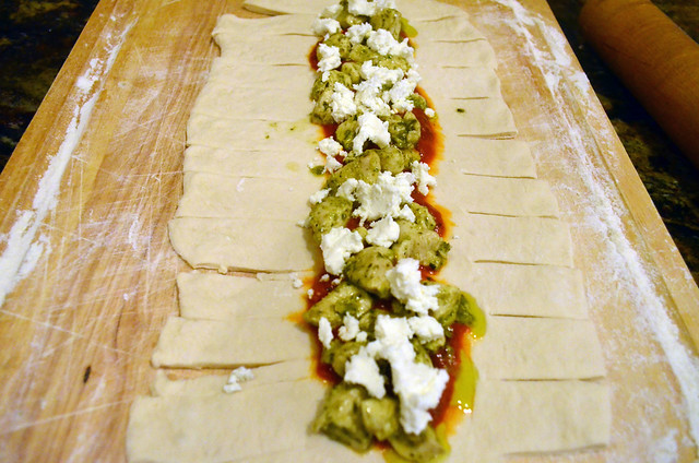 A chicken Pesto mixture and goat cheese added on top of the dough.
